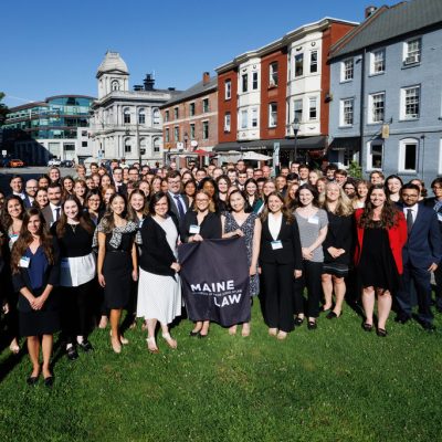 Photo of the class of 2026 standing outside the Maine Law Building
