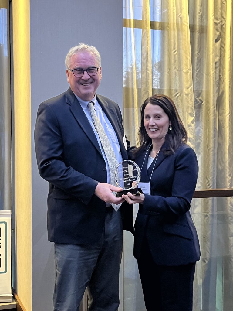 Photo of Northrop holding an award standing next to Michelle Draeger, Executive Director of the Maine Justice foundation 