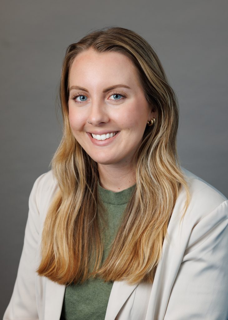 Headshot of Jump in beige blazer.