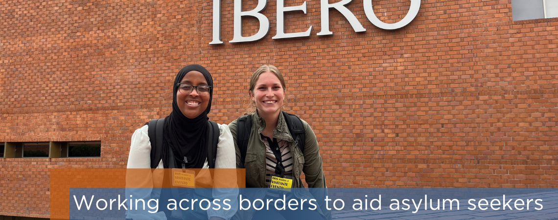 Photo shows two students sitting side-by-side in front of sign that says "Ibero." Headline reads: Working across borders to aid asylum seekers