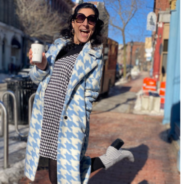 Photo of Shea Watson on the sidewalk dressed in blue and white checkered coat